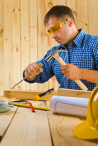 Man working with tools wearing safety glasses